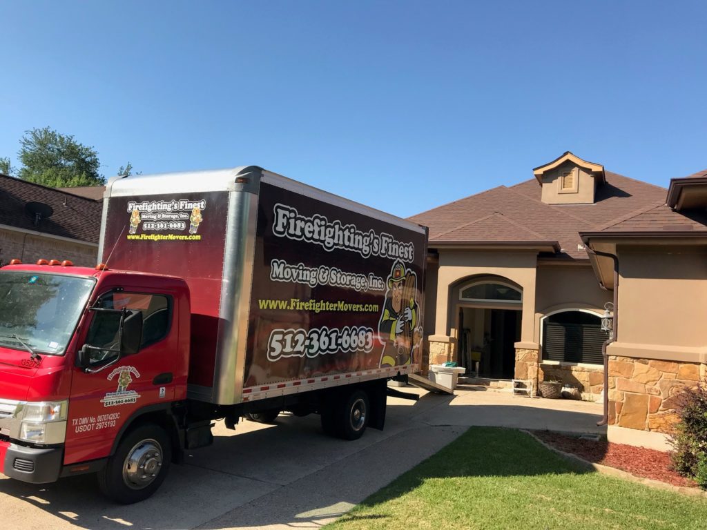 Firefighting's Finest Moving & Storage truck parked in front of a residential home in Austin, Texas