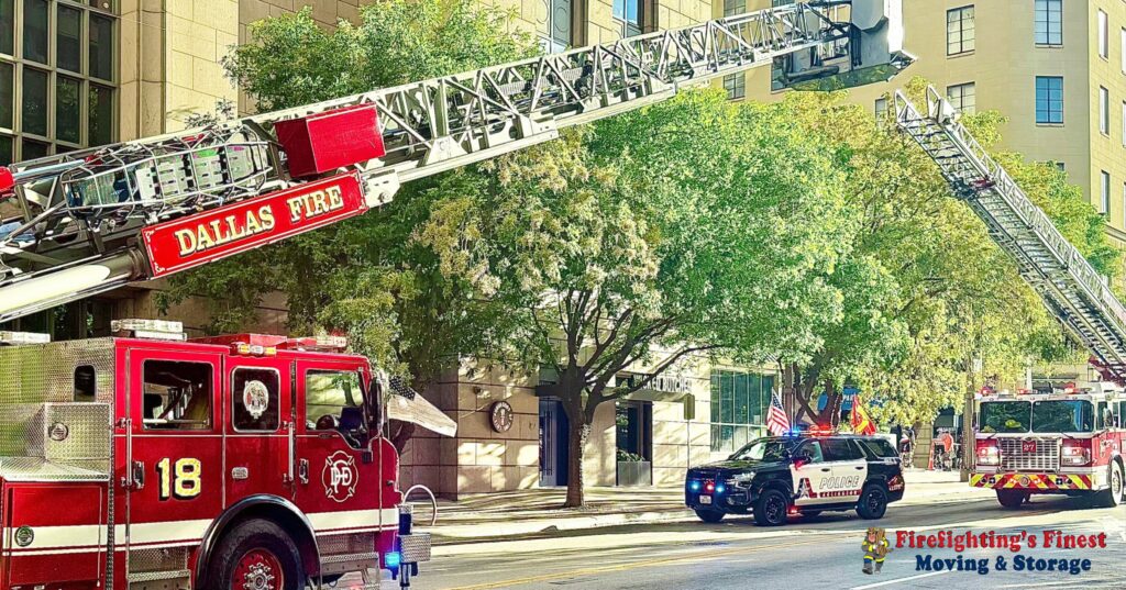 Dallas Fire trucks with extended ladders parked on a downtown street, showcasing the first responder roots of Firefighting's Finest Moving & Storage.