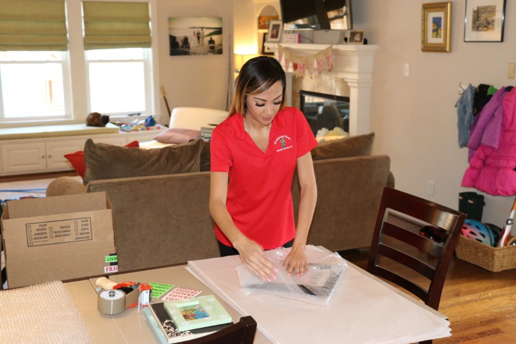 A team member from Firefighting’s Finest Moving & Storage Moving carefully packed a picture frame during a Fort Worth, Texas, move