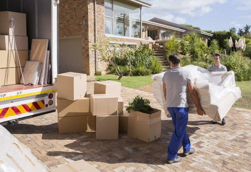 Two professionals are moving furniture to a new home in Houston, TX