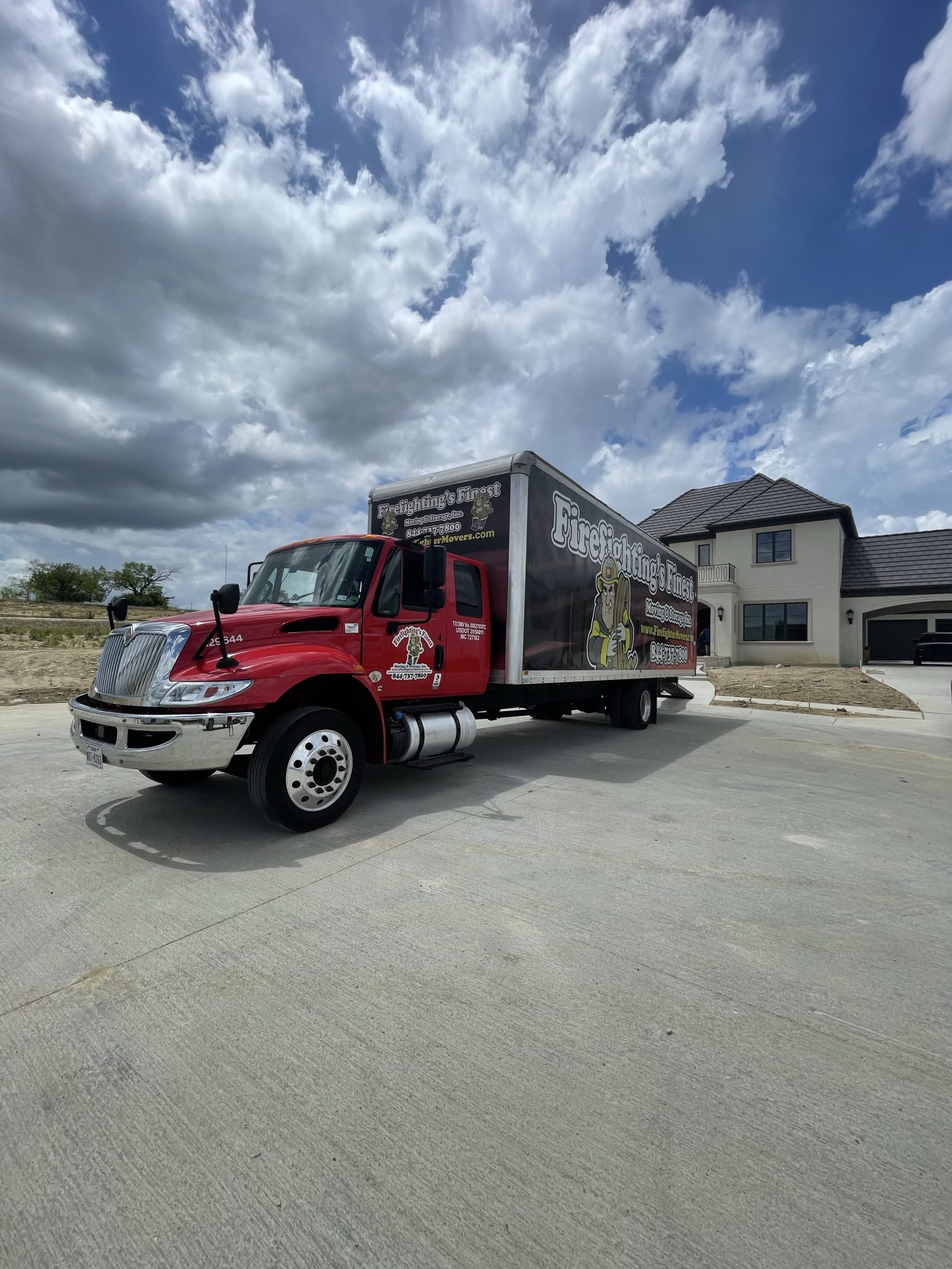 Firefighting's Finest Moving & Storage truck parked in front of home