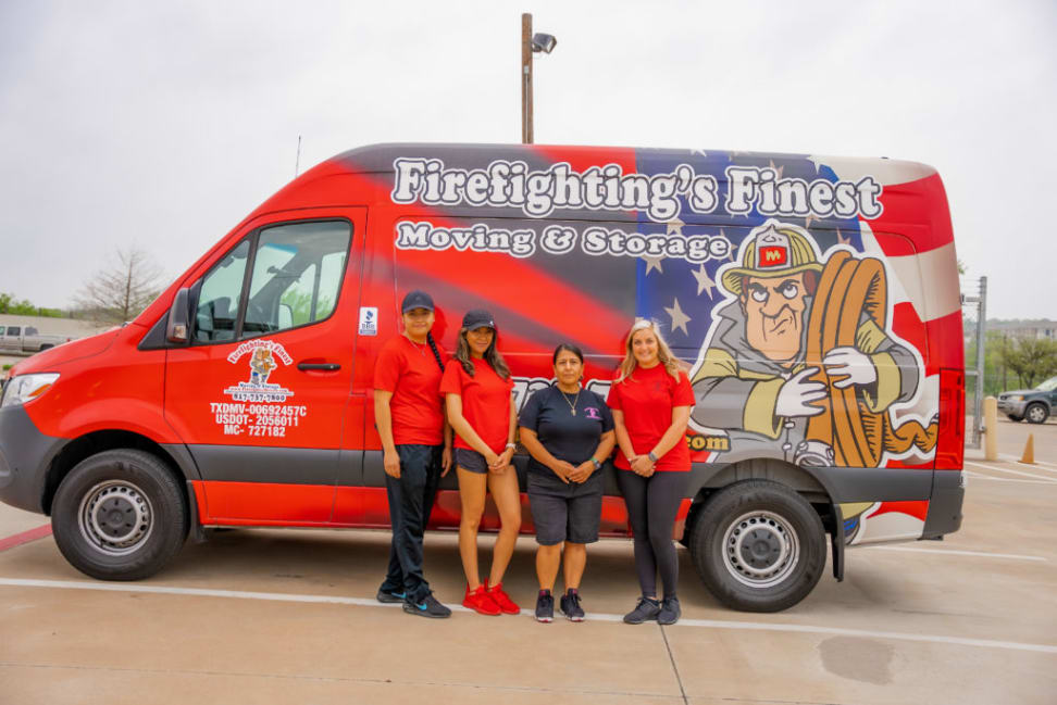 Firefighting’s Finest Moving & Storage packing team with branded moving van in the background