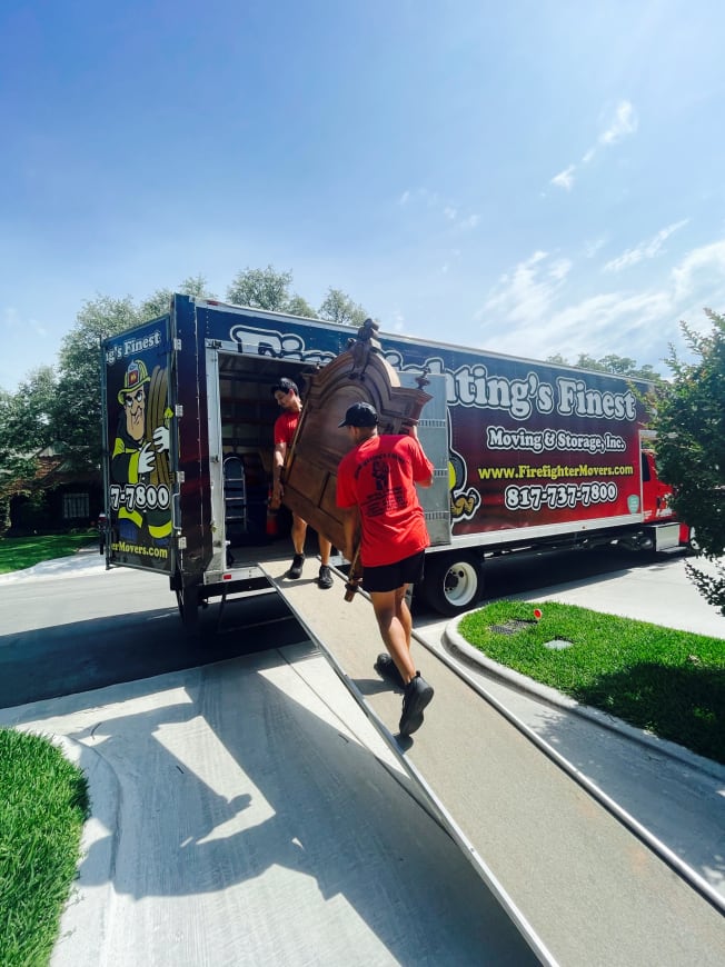 Firefighting's finest moving and storage employees loading furniture into a truck in Texas