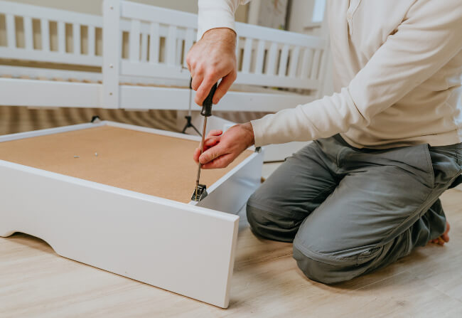 A team member performing furniture reassembly services in Fort Worth, Dallas, Houston, and Austin, Texas